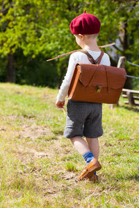 Full length of boy walking on grass