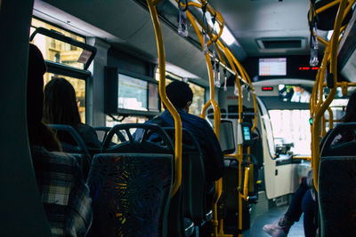 Rear view of people sitting in train