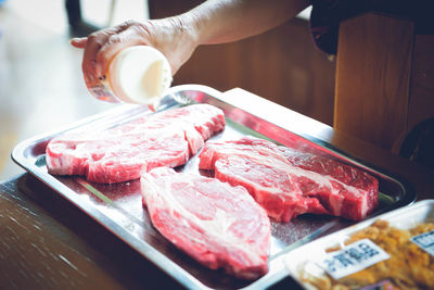 Close-up of person preparing food on table