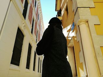 Woman standing in front of building