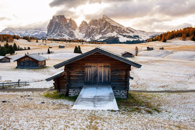 Built structure on snowcapped mountain against sky