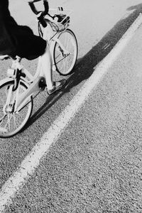 Low section of person riding bicycle on road