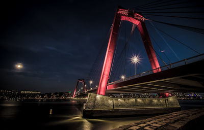 View of bridge over river at night