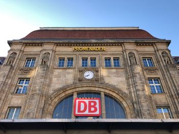 Low angle view of sign on building against sky