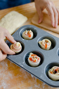 Close-up of person preparing food on table