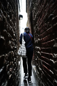 Rear view of woman walking on walkway
