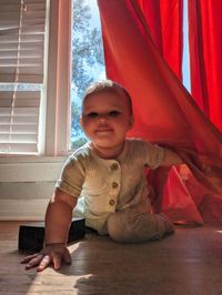 Portrait of cute boy sitting in tent