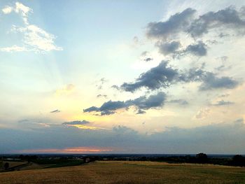 Scenic view of land against sky during sunset