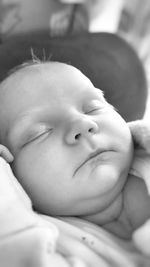 Close-up of baby sleeping on bed