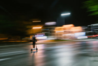 Man running on illuminated street at night