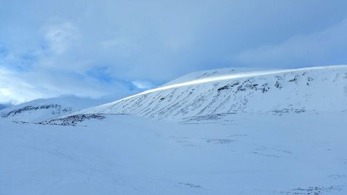 Scenic view of snow mountains against sky