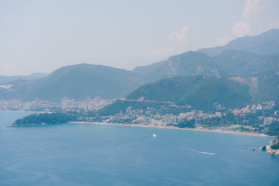 Scenic view of sea and mountains against sky