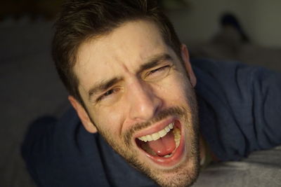 Close-up portrait of man screaming outdoors