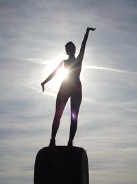 Young woman jumping at sunset
