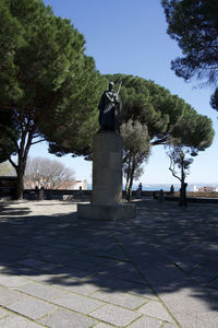 Statue in park against clear sky
