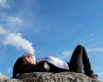 Woman sitting against sky
