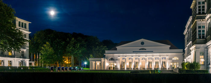 Buildings against blue sky at night