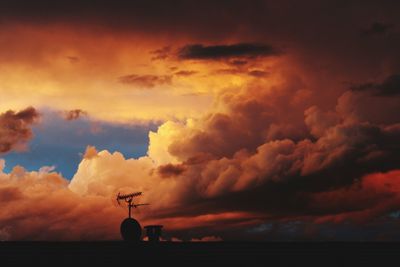 Scenic view of silhouette field against sky during sunset