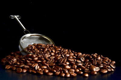 Close-up of coffee beans against black background