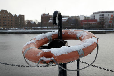 Close-up of snow on city against sky