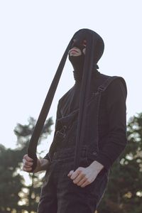 Man wearing mask against clear sky