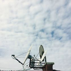Low angle view of communications tower against sky