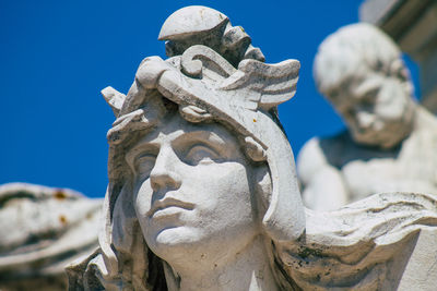 Close-up of angel statue against clear sky