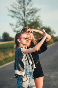 Girl gesturing by friend in city