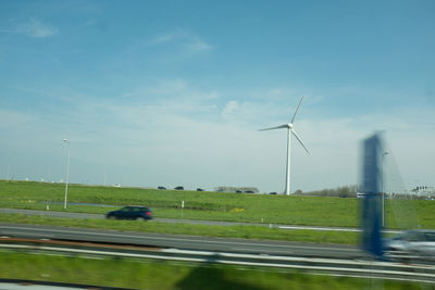 Windmills against sky