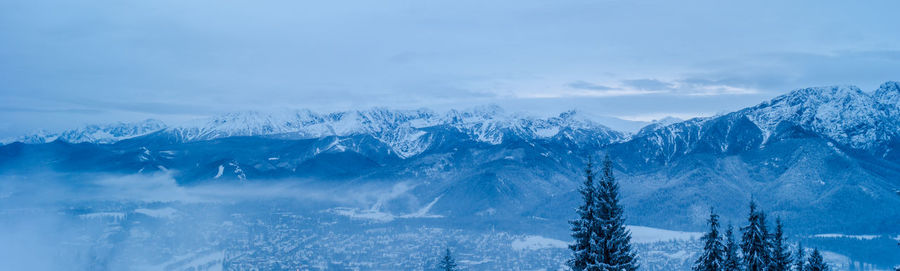 Scenic view of snowcapped mountains against sky