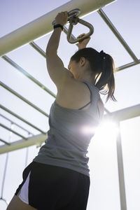 Rear view of woman exercising outdoors