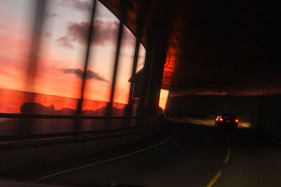 Cars on road at sunset