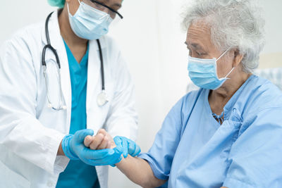 Doctor examining patient in hospital