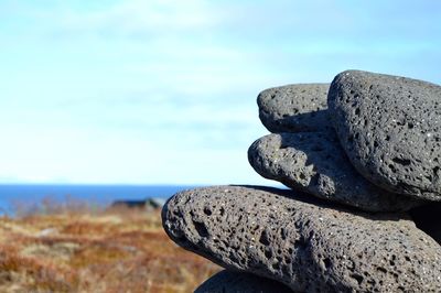 Rocks on sea shore against sky