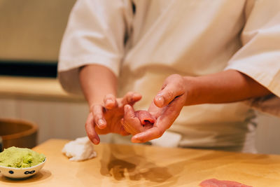 Midsection of man preparing food in kitchen