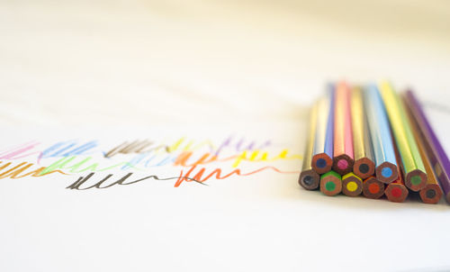 Close-up of colorful pencils on white background