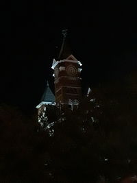 Low angle view of illuminated building against sky at night