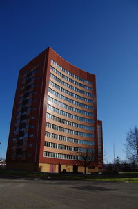 Low angle view of buildings against clear blue sky