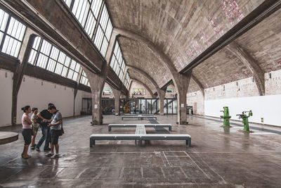 People walking in corridor of building