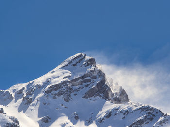 Scenic view of snowcapped mountains against clear blue sky