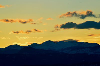 Scenic view of mountains against cloudy sky