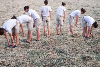 Multiple image of young man standing on field