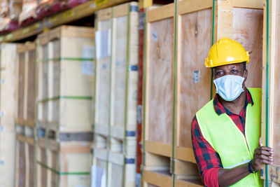 Portrait of worker wearing hardhat and mask