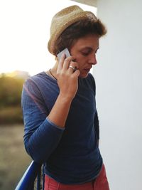 Young man standing against wall