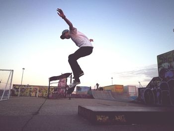 Full length of man skateboarding on skateboard against sky