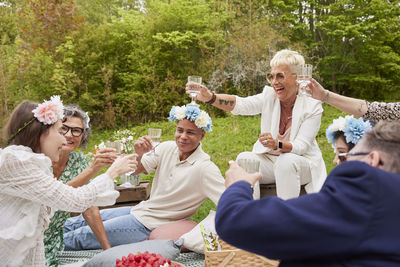 Family raising toast at picnic