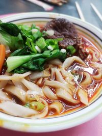 Close-up view of spicy home-made beef-bone soup noodles