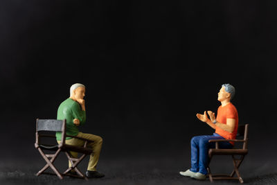 Miniature people therapist and patient talking together