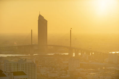 Modern buildings in city during sunset