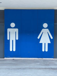 Information sign of man and woman on white wall